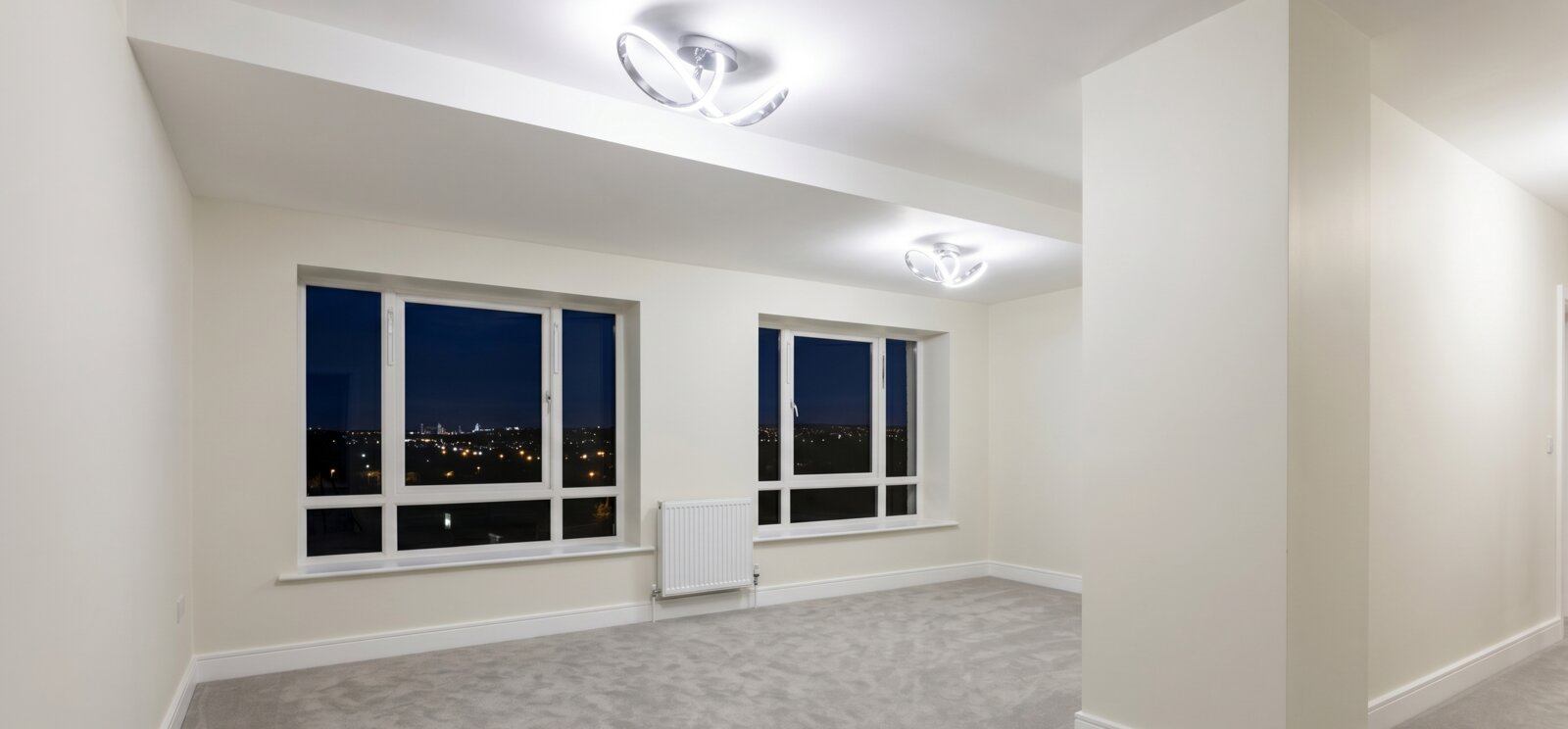 Freshly painted Dublin reception room with large windows, new carpet, and bright white walls